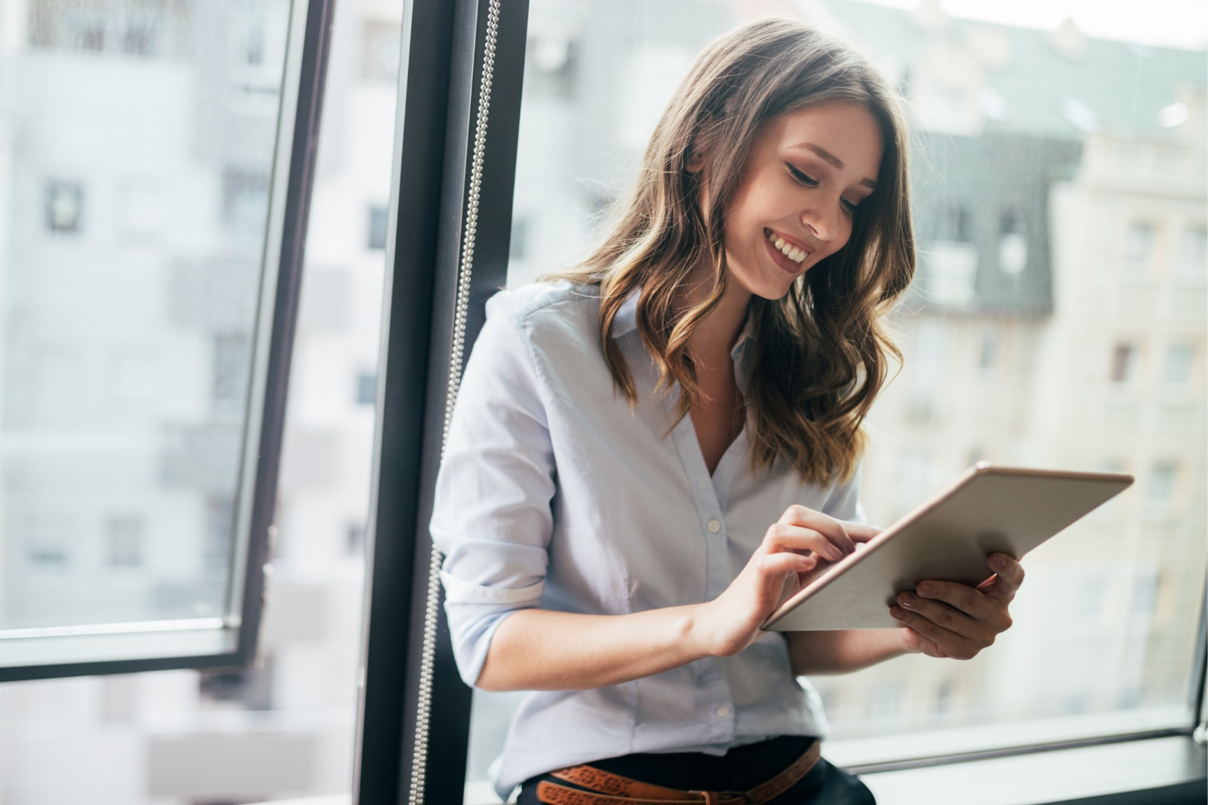 Smiling woman working with a tablet