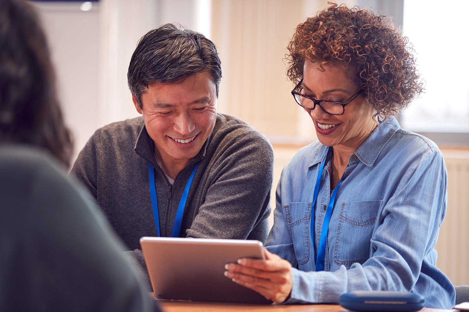 Image of two people viewing a tablet