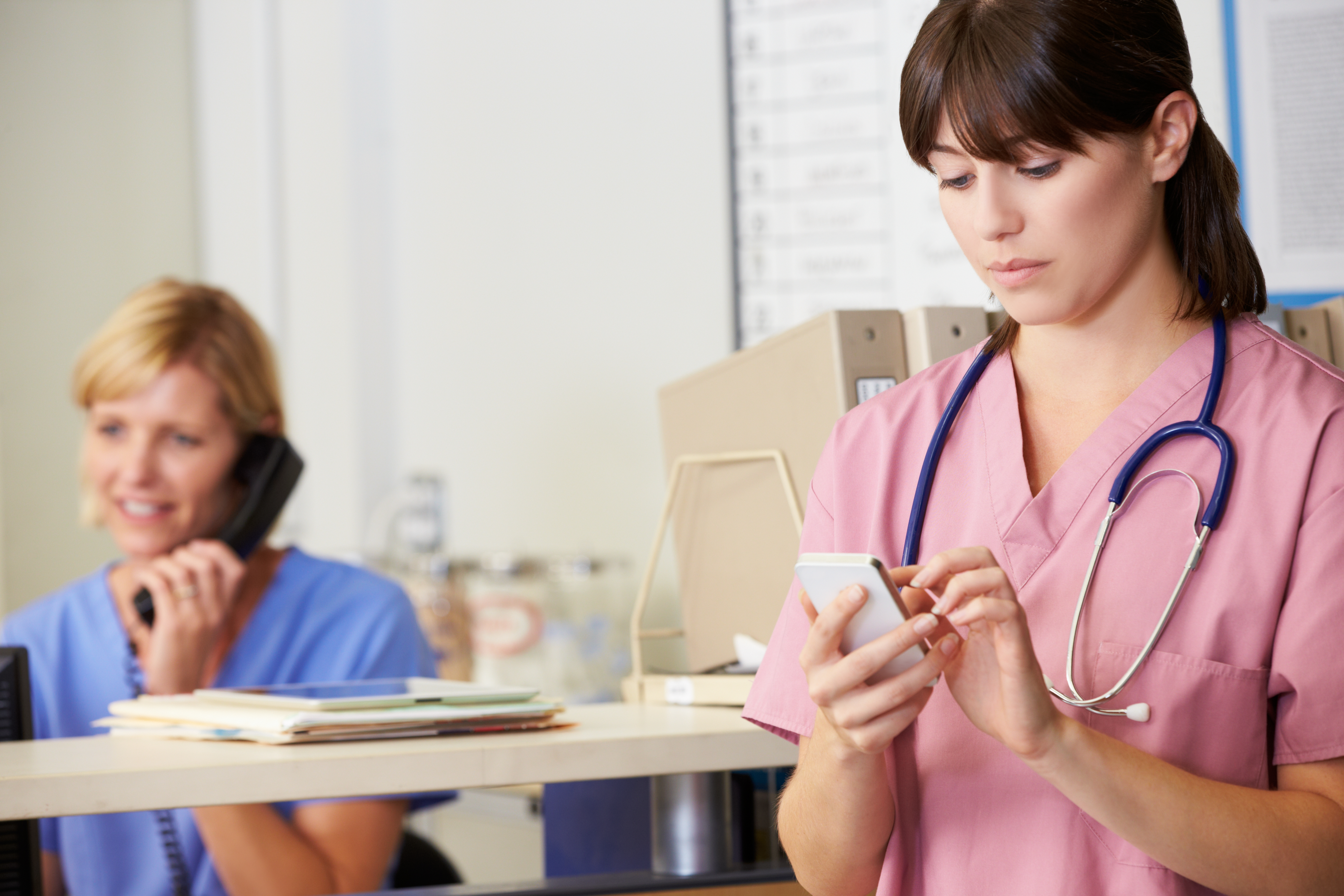 Image of a nurse viewing a mobile device