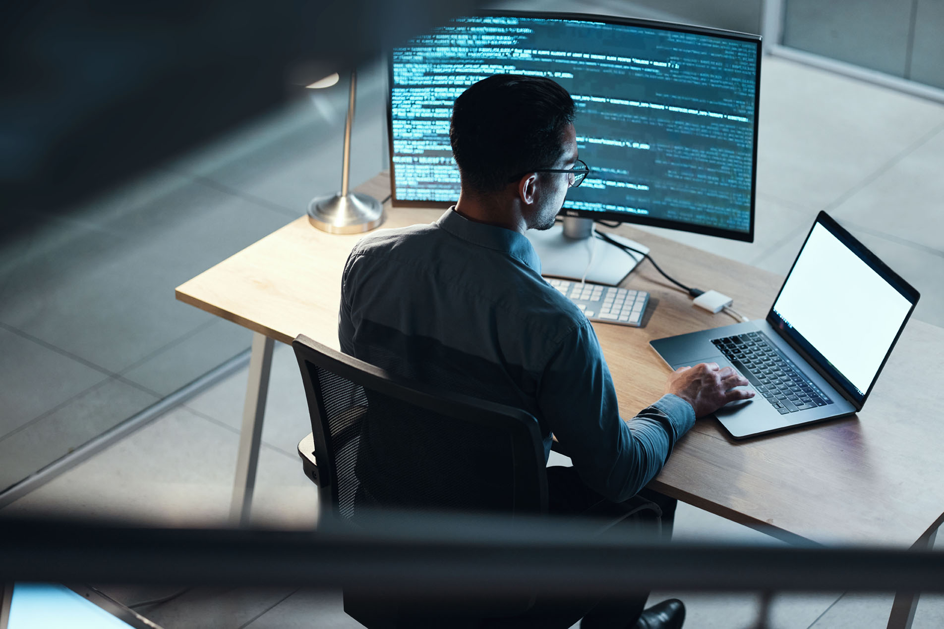 man viewing data on monitor